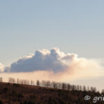 Volcano cloud in a distance and a sunset